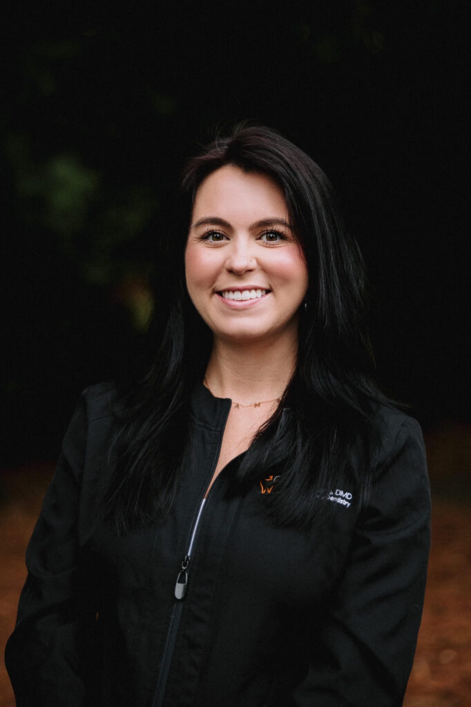 Young female dental assistant smiling